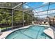 Inviting pool with screened enclosure, providing a serene backyard oasis at 165 Scrub Jay Way, Davenport, FL 33896