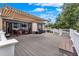 Large back deck featuring a retractable awning, dining area, stainless steel grill, with room for entertaining at 1692 Blue Grass Blvd, Deland, FL 32724