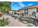 Scenic backyard highlighting a picturesque pond, rock features, and mature landscaping at 1692 Blue Grass Blvd, Deland, FL 32724