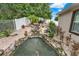 Backyard showcasing a rock pond with a waterfall, plants and landscaping for a tranquil outdoor living at 1692 Blue Grass Blvd, Deland, FL 32724
