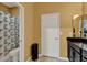 Bathroom featuring a vanity with sink, mirror, and a shower/tub combination with a decorative curtain at 1692 Blue Grass Blvd, Deland, FL 32724