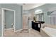 Bathroom featuring a walk-in shower, soaking tub, black vanity and modern fixtures at 1692 Blue Grass Blvd, Deland, FL 32724