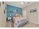 Bright bedroom with a fun, decorative theme and a colorful, themed comforter at 1692 Blue Grass Blvd, Deland, FL 32724