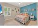 Colorful bedroom with natural light, cute décor, and a cozy bed at 1692 Blue Grass Blvd, Deland, FL 32724