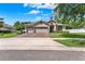 Charming single-story home featuring a three-car garage and well-manicured landscaping at 1692 Blue Grass Blvd, Deland, FL 32724