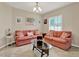 Inviting living room featuring neutral walls, tile floors, and comfortable seating area at 1692 Blue Grass Blvd, Deland, FL 32724
