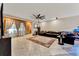 Spacious living room with tile flooring, ceiling fan, and access to the outdoor area at 1692 Blue Grass Blvd, Deland, FL 32724