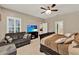 Spacious main bedroom featuring a seating area, large bed, and elegant ceiling fan at 1692 Blue Grass Blvd, Deland, FL 32724