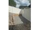 Small, private patio area surrounded by a white fence and rock landscaping at 1692 Blue Grass Blvd, Deland, FL 32724