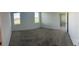 Bright bedroom with two windows and neutral carpeting, offering a serene and comfortable space at 1889 Blissful Dr, Kissimmee, FL 34744