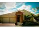 Charming single-story home with a brick-accented entrance and two-car garage at 1889 Blissful Dr, Kissimmee, FL 34744