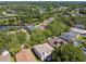 Aerial view of a neighborhood with mature trees, and a lake at 1936 Westpointe Cir, Orlando, FL 32835