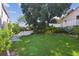 Well-maintained backyard with mature trees, shrubs, and a privacy fence at 1936 Westpointe Cir, Orlando, FL 32835