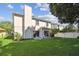 Manicured backyard with lush green grass and patio seating area at 1936 Westpointe Cir, Orlando, FL 32835