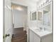 This bathroom features a white vanity with a large mirror, and tiled walls at 1936 Westpointe Cir, Orlando, FL 32835
