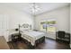 Bright bedroom with ceiling fan, window with blinds, and dark wood-look flooring at 1936 Westpointe Cir, Orlando, FL 32835
