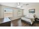 This spacious bedroom features two windows, luxury vinyl floors, and a ceiling fan at 1936 Westpointe Cir, Orlando, FL 32835