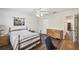 Bright bedroom with wood floors, ceiling fan, and a door leading to other rooms at 1936 Westpointe Cir, Orlando, FL 32835