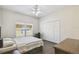 Bedroom with ceiling fan, closet, dark wood-look floors, and natural light from window at 1936 Westpointe Cir, Orlando, FL 32835
