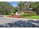 Well-manicured community entrance with vibrant landscaping and clear signage for MetroWest at 1936 Westpointe Cir, Orlando, FL 32835