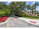 Community entrance with a paved drive, landscaping, and shrubbery at 1936 Westpointe Cir, Orlando, FL 32835
