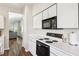 Bright kitchen with a white countertop, black appliances, and easy living room access at 1936 Westpointe Cir, Orlando, FL 32835