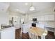 Bright, all-white kitchen with a central island, modern appliances, and dark wood flooring at 1936 Westpointe Cir, Orlando, FL 32835