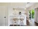 Open kitchen with a breakfast bar, white cabinetry, and seamless access to the patio at 1936 Westpointe Cir, Orlando, FL 32835