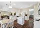 Open kitchen flows into the living area, features a kitchen island, and stainless appliances at 1936 Westpointe Cir, Orlando, FL 32835