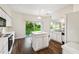 Bright eat-in kitchen with white cabinets, a center island, and sliding glass doors to the backyard at 1936 Westpointe Cir, Orlando, FL 32835