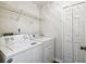 Laundry room with a washer, dryer, wire shelf, and closet for storage at 1936 Westpointe Cir, Orlando, FL 32835