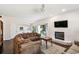 Inviting living room with fireplace, plush sectional, and seamless access to the patio at 1936 Westpointe Cir, Orlando, FL 32835