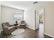 Sitting area with vinyl flooring, window, and doorway to bedroom at 1936 Westpointe Cir, Orlando, FL 32835