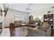 Spacious living room with large windows, cozy seating arrangements, and stylish decor at 1936 Westpointe Cir, Orlando, FL 32835