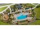 Aerial view of community pool, playground, and lounge area with palm trees, umbrellas, and chairs at 2273 White Buffalo St, Apopka, FL 32703