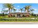 Exterior view of the community clubhouse, showcasing manicured landscaping, tropical palms, and a welcoming entrance at 2273 White Buffalo St, Apopka, FL 32703