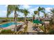 Resort-style pool area surrounded by palm trees, lounge chairs, and lush landscaping offering a relaxing oasis at 2273 White Buffalo St, Apopka, FL 32703