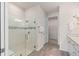 Modern bathroom featuring a glass-enclosed shower, neutral color palette, and tile flooring at 2348 Daisy Tree Rd, St Cloud, FL 34771