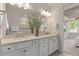 Bright bathroom featuring double sinks, ample counter space, and a view into the shower at 2348 Daisy Tree Rd, St Cloud, FL 34771