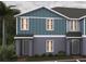 Charming two-story townhome featuring a blend of gray and blue siding, offering a modern and appealing exterior design at 2420 Cabinwood Range Way, Eustis, FL 32726