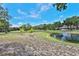 Expansive backyard overlooking a pond, mature trees, and a manicured lawn at 247 W Sabal Palm Pl, Longwood, FL 32779