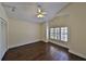 Bedroom with hardwood floors, a ceiling fan, and a large arched window at 247 W Sabal Palm Pl, Longwood, FL 32779