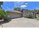 Charming home featuring a two-car garage, a well-manicured lawn, and a welcoming front entrance at 247 W Sabal Palm Pl, Longwood, FL 32779