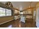 Bright kitchen features an island, granite countertops, stainless steel appliances, and wood floors at 247 W Sabal Palm Pl, Longwood, FL 32779