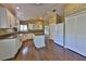 Bright kitchen features an island, granite countertops, stainless steel appliances, and wood floors at 247 W Sabal Palm Pl, Longwood, FL 32779
