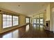 Spacious living room featuring wood floors, a fireplace, large windows, and lots of natural light at 247 W Sabal Palm Pl, Longwood, FL 32779