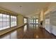 Spacious living room featuring wood floors, a fireplace, large windows, and lots of natural light at 247 W Sabal Palm Pl, Longwood, FL 32779