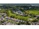 Expansive aerial view of a residential community with lush green spaces, golf course, and serene water features at 2638 Clarinet Dr, Orlando, FL 32837