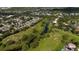 A stunning aerial view captures a residential area with winding waterways and houses nestled in lush landscapes at 2638 Clarinet Dr, Orlando, FL 32837