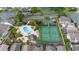 Aerial shot showcases a community pool, tennis court, and well-maintained properties surrounded by lush landscaping at 2638 Clarinet Dr, Orlando, FL 32837